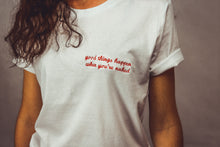 Load image into Gallery viewer, white unisex tshirt with embroidered &quot;good things happen when you&#39;re naked&quot; design
